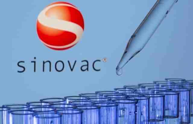 Test tubes are seen in front of a displayed Sinovac logo in this illustration taken, May 21, 2021. REUTERS/Dado Ruvic/Illustration/File Photo