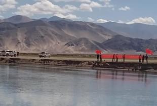 Chinese soldiers showing protest banners to Indian villagers in Ladakh.