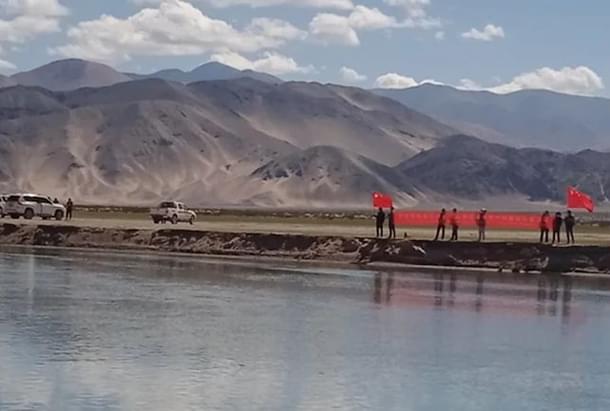 Chinese soldiers showing protest banners to Indian villagers in Ladakh.