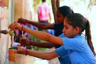 A student utilizing tap water facility in a school (PIB)