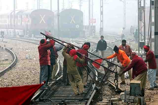 Indian Railways employees work on a railway track in New Delhi. (RAVEENDRAN/AFP/Getty Images)