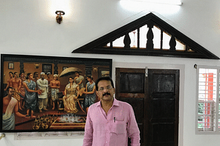 Prof Poojary with a painting showing the coronation of Rani Abbakka
