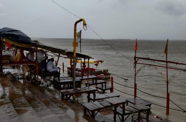 Pandits wait by the bank of River Sarayu