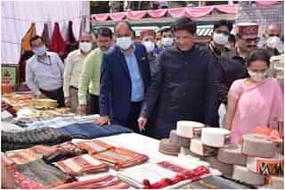 Piyush Goyal taking a look at handloom products in Kullu, Himachal Pradesh.