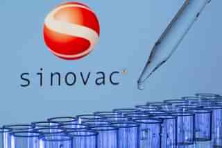 Test tubes are seen in front of a displayed Sinovac logo in this illustration taken, May 21, 2021. REUTERS/Dado Ruvic/Illustration/File Photo