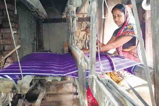 Woman weaving cloth