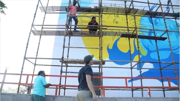 The mural of shri ram with French artist Chifumi in the foreground