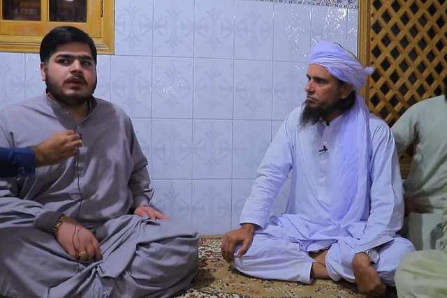 The pujari (left) and Tariq Masood

