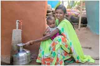 A woman using tap water connection provided by Jal Jeevan Mission. (Jal Jeevan Mission/Facebook)