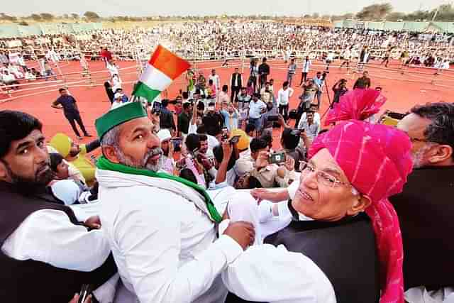 Bharatiya Kisan Union leader Rakesh Tikait with farmers at a protest rally.