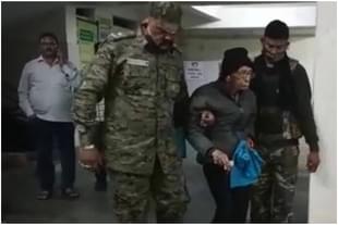 Prashanta Bose being taken into custody.