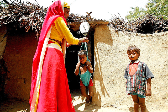 Indian Anganwadi worker weighs a 
malnourished child. (MANAN VATSYAYANA/AFP/Getty Images) 