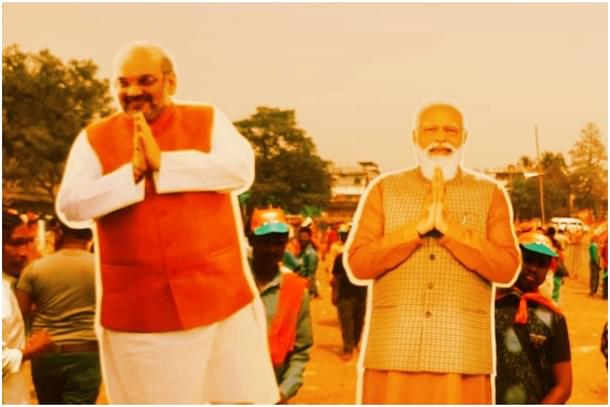 Cutouts of Home Minister Amit Shah (L) and Prime Minister Narendra Modi