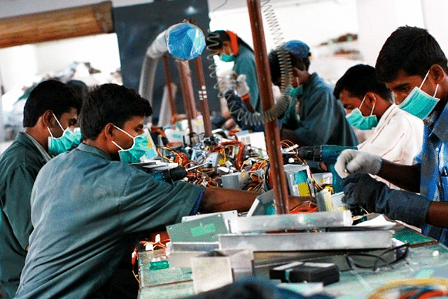 Factory workers in India (Uriel Sinai/Getty Images)