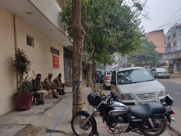 Security personal sitting across the road from Dablu’s house