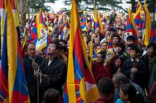Tibetan national flag being raised to mark Tibetan national uprising