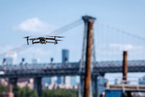 A DJI drone flying near the Brooklyn Bridge