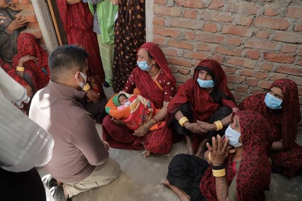 Minister Harsh Sanghavi with Kishan’s family holding Kishan’s 20-day-old daughter