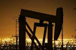 Pumps draw petroleum from oil wells through the night. (David McNew/Getty Images)