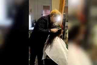 Hairstylist Jawed Habib spitting on the woman's head.