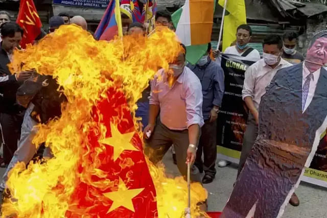 Tibetan exiles burning Chinese flag (Representative Image)