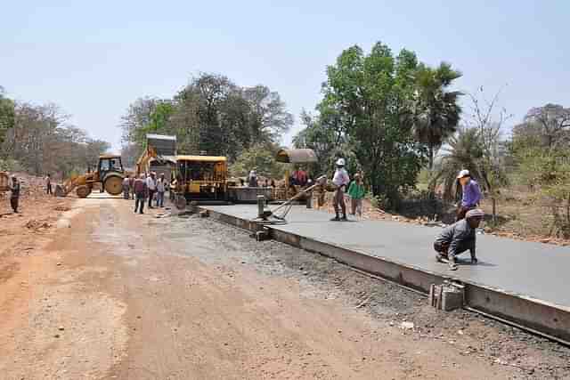 Workers laying a road.