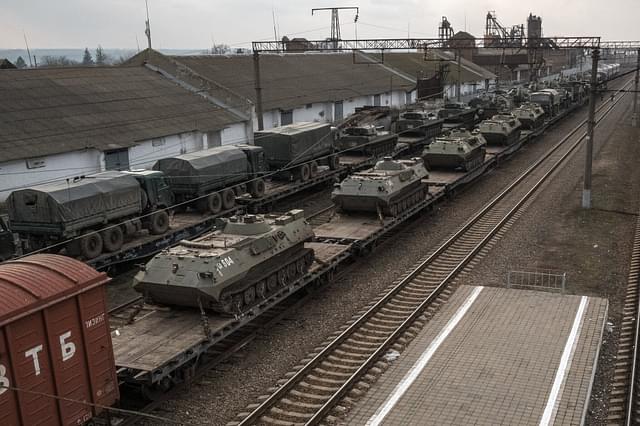 Russian battle tanks being loaded onto a train car outside Taganrog, Russia| Credits: New York Times 