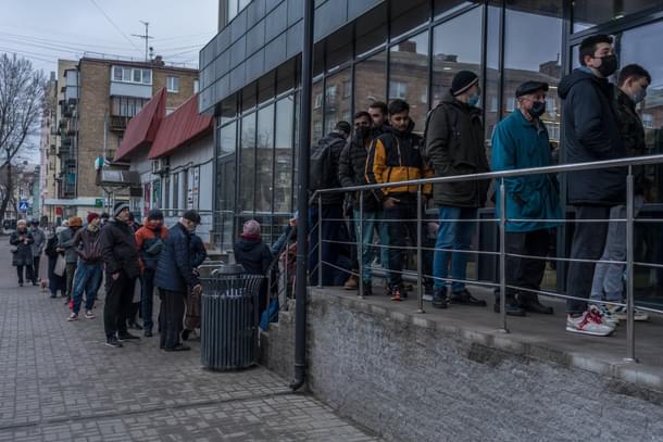 People queuing outside a store in Kyiv | Credits: New York Times