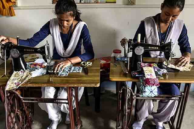 Schoolgirls making reusable sanitary napkins.