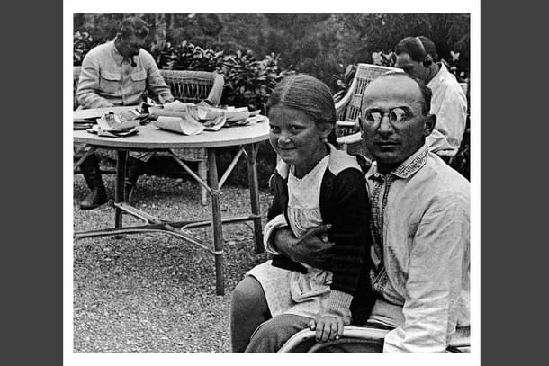 A troubling picture: Stalin's daughter with Beria. Many body language experts detect uneasiness in the child's posture.