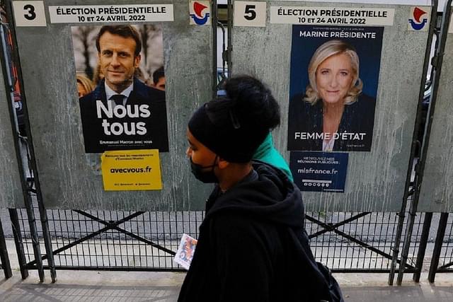 Posters of French President Emmanuel Macron and challenger Marine Le Pen.