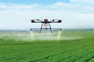 A drone spraying pesticide on crop.