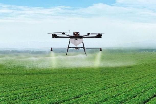 A drone spraying pesticide on crop.