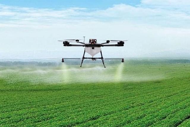 A drone spraying pesticide on crop. 