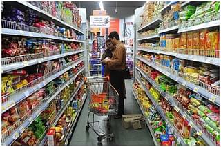 A family shops at a supermarket. (INDRANIL MUKHERJEE/AFP/GettyImages)  