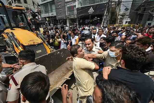 Congress and AAP supporters stop the demolition drive.