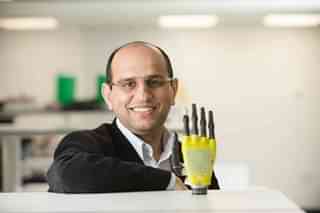 Prof. Ravinder Dahiya with a robotic arm  with the sense of touch