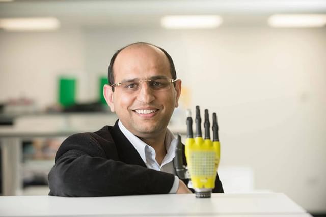Prof. Ravinder Dahiya with a robotic arm  with the sense of touch