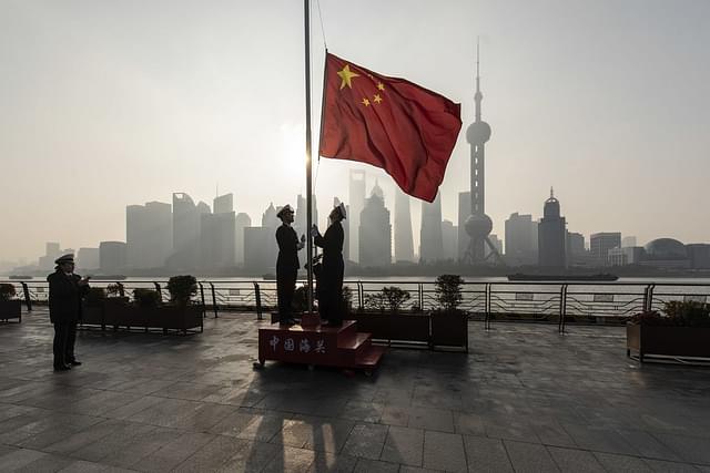 Soldiers hoisting the flag of People's Republic  of China in Shanghai. 