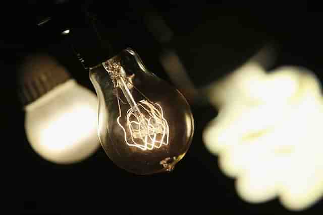 A vintage-style incandescent light bulb (C), with an LED light bulb (L) and a compact florescent (CFL) light bulb (Scott Olson/Getty Images)