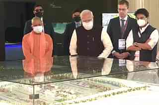 UP CM Yogi, PM Modi and Minister Scindia looking at a model of Noida international airport (ANI)