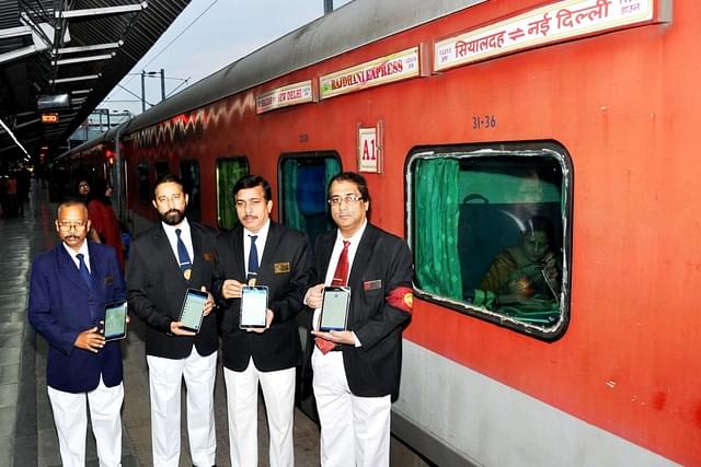 TTEs hold Hand Held Terminals for Sealdah – New Delhi Rajdhani Express.