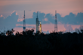 The SLS at sunrise is seen above the tree line. (Photo: NASA Artemis/Twitter)