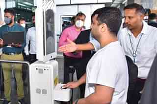 Staff at Kempegowda International Airport Bengaluru guide the first passenger to use the DigiYatra face recognition system on 15 August.