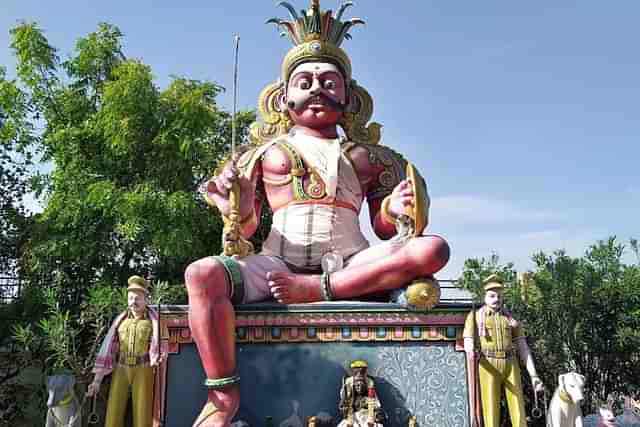 The village guardian Deity in a temple in Tamil Nadu, flanked by policemen and two police dogs. 

