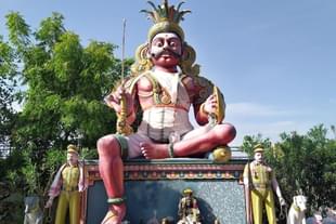The village guardian Deity in a temple in Tamil Nadu, flanked by policemen and two police dogs.