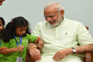 A girl ties 'Rakhi' on PM Modi's wrist on the occasion of Raksha Bandhan (Source: PIB)