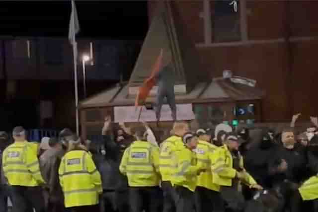 A still from a video of saffron flag being pulled down.