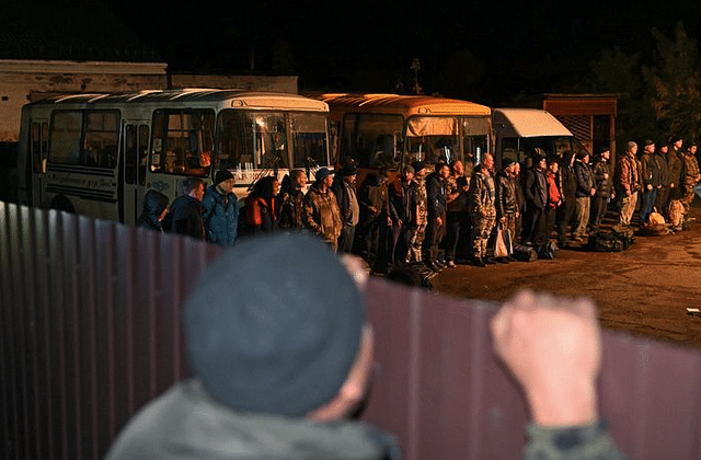 Reservists line up outside a recruitment office in the Siberian town of Tara.
