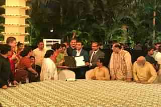 In happier times: the ceremony last year where Karan Adani was handed over the LoI for the Tajpur project.